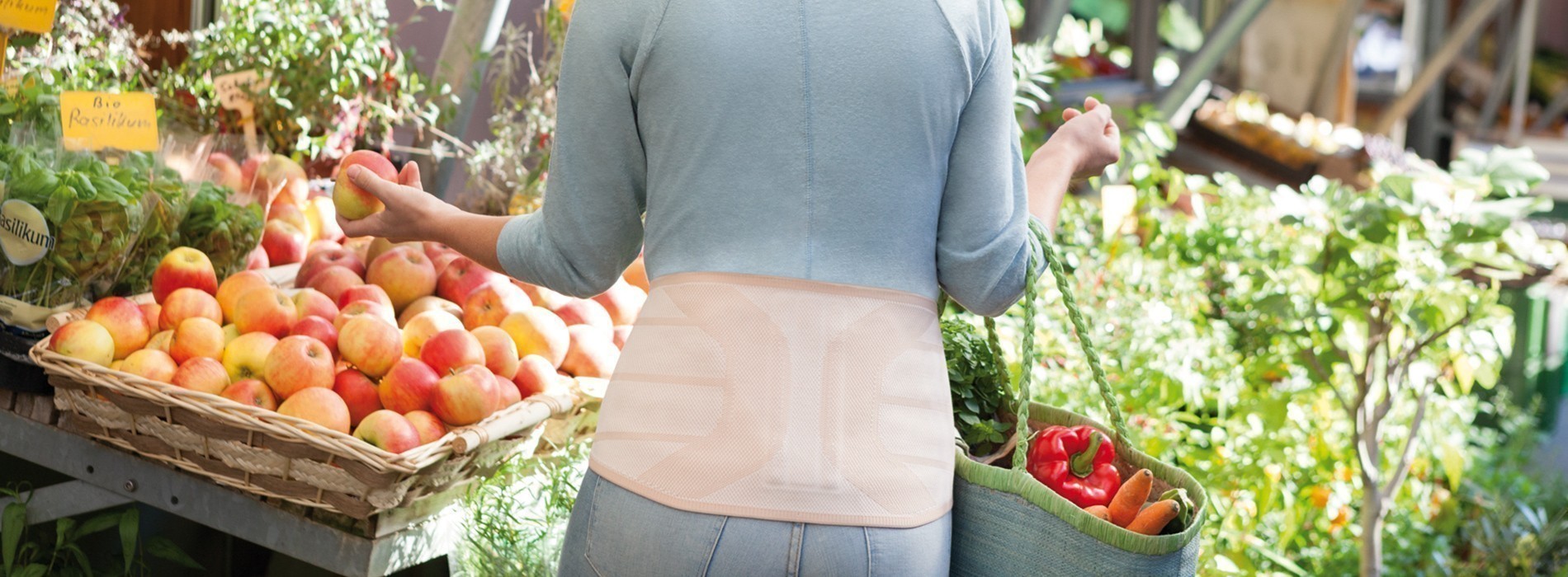 Back orthosis Woman in supermarket wearing back orthosis