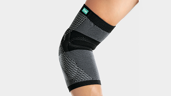 A hiker is wearing a Juzo elbow support