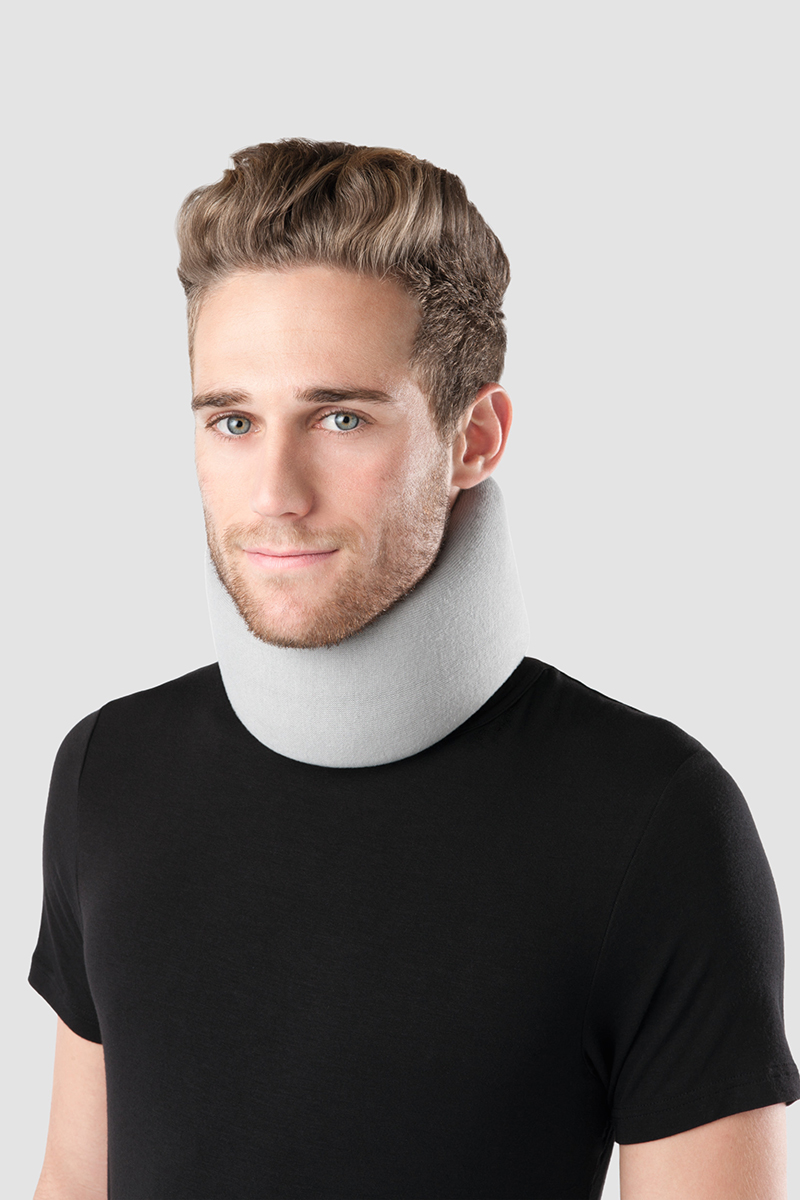 A man is wearing a Juzo cervical support around his neck. A man is wearing a Juzo cervical support around his neck.