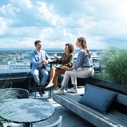 A man and two women are on a rooftop terrace wearing compression stockings.A man and two women are on a rooftop terrace wearing compression stockings.