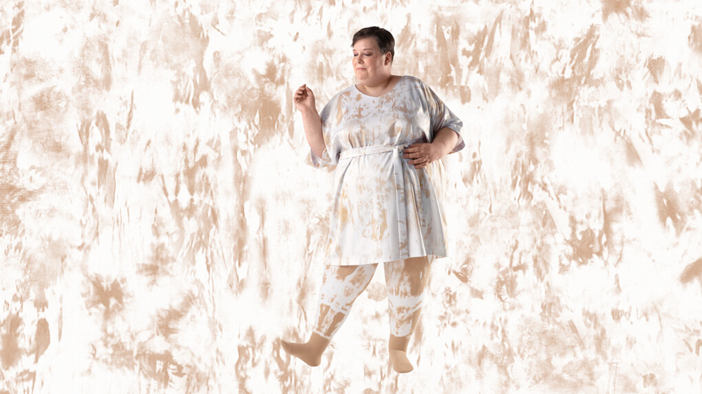 A woman wearing batik-patterned compression stockings against a batik-patterned background A woman wearing batik-patterned compression stockings against a batik-patterned background
