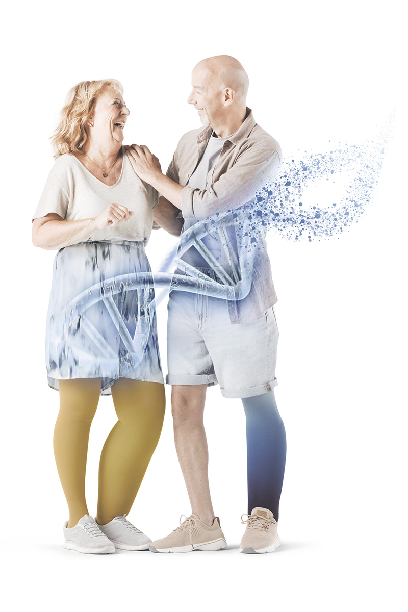 Two people are laughing together. In the foreground is a diagram of DNA