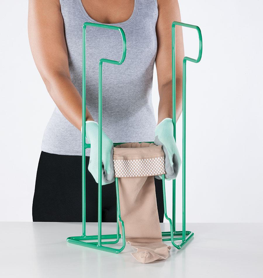 A person demonstrates the Juzo Easy Fit dressing aid