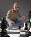 2. Lifestyle Image Juzo Dynamic Man and woman in Juzo Dynamic stockings standing on a large chessboard