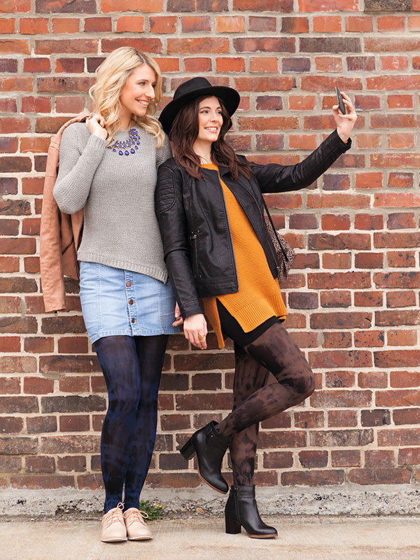 Juzo Batik Collection Two women leaning against a wall. They are wearing compression stockings with batik pattern